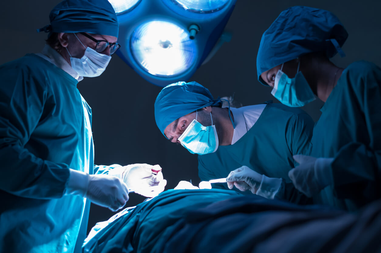 Group of concentrated surgical doctor team doing surgery patients in hospital operating